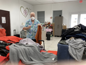 Reverend John Knight - Hermandad President sorting clothes at CorMA